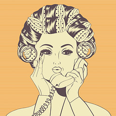 Image showing Woman with curlers in their hair talking at phone