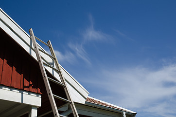 Image showing Ladder at a tiled roof