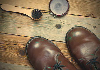 Image showing Still life with brown boots, shoe polish and shoe brush