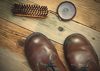 Image showing Still life with brown boots, shoe polish and brush