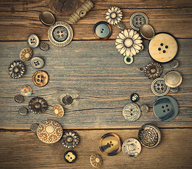 Image showing several old buttons on the vintage table surface