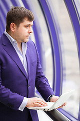 Image showing businessman standing near a window