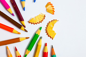 Image showing several colored pencils and shavings on white background