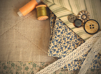 Image showing fabric, thread reels, buttons and lace tapes