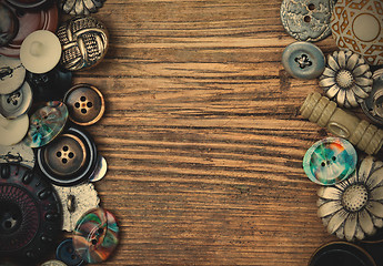 Image showing set of vintage buttons on aged boards