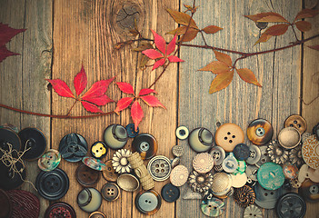 Image showing vintage buttons with dried branches and red leaves