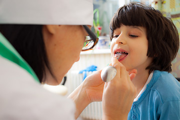 Image showing doctor otolaryngologist looking boy throat