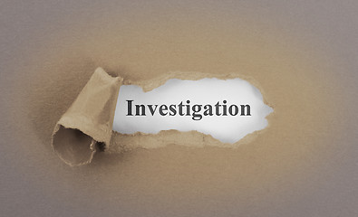 Image showing Text appearing behind torn brown envelop