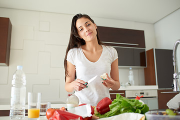 Image showing Young Woman Cooking in the kitchen