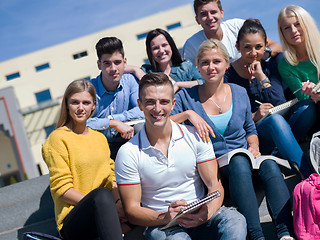 Image showing students outside sitting on steps