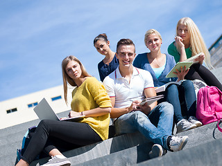 Image showing students outside sitting on steps