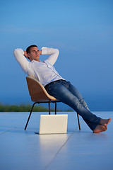 Image showing relaxed young man at home on balcony