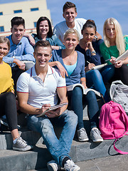 Image showing students outside sitting on steps