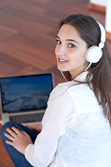 Image showing relaxed young woman at home working on laptop computer