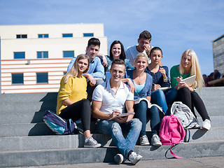 Image showing students outside sitting on steps