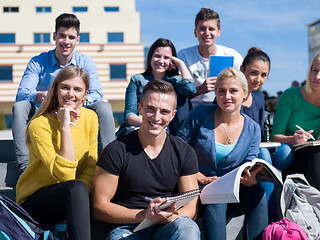 Image showing students outside sitting on steps