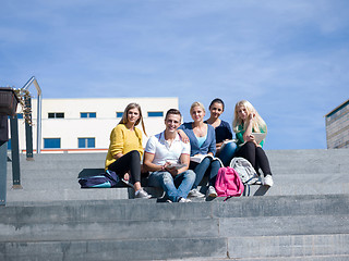 Image showing students outside sitting on steps