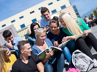 Image showing students outside sitting on steps