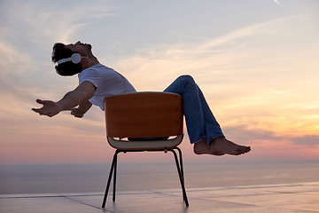 Image showing relaxed young man at home on balcony