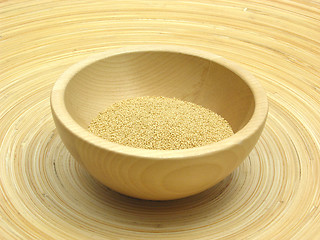 Image showing Wooden bowl with amaranth on bamboo plate