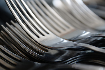 Image showing Forks arranged in series on the kitchen table.