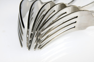 Image showing Forks arranged in series on the kitchen table.