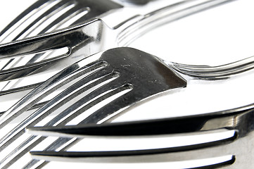 Image showing Forks arranged in series on the kitchen table.