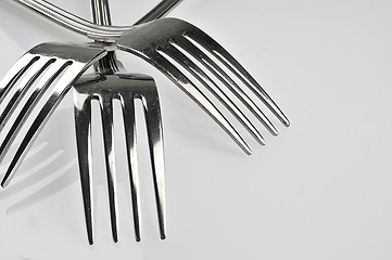 Image showing Forks arranged in series on the kitchen table.