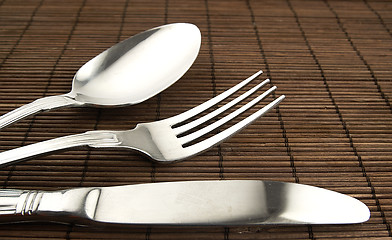 Image showing Cutlery on a wooden background.