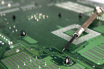 Image showing Computer motherboard and Screwdriver.