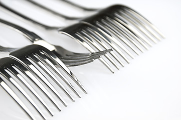 Image showing Forks arranged in series on the kitchen table.