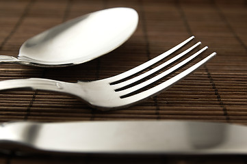 Image showing Cutlery on a wooden background.