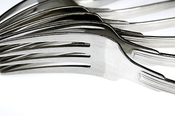 Image showing Forks arranged in series on the kitchen table.