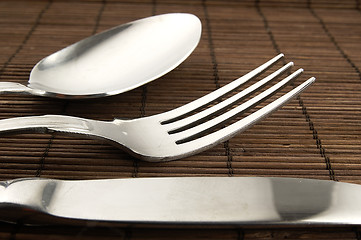 Image showing Cutlery on a wooden background.