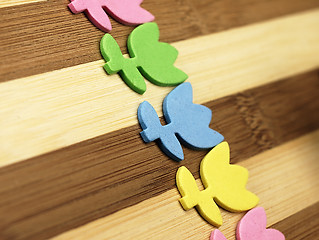 Image showing Colorful cut tulips on a chopping board.