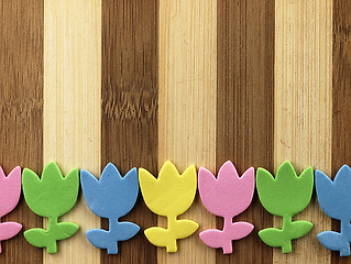 Image showing Colorful cut tulips on a chopping board.