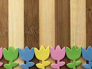 Image showing Colorful cut tulips on a chopping board.