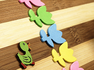 Image showing Colorful cut tulips and duck on a chopping board.