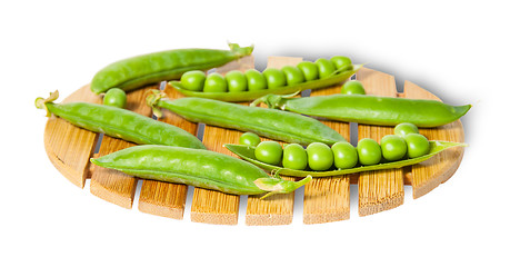 Image showing Pods of peas on bamboo small board