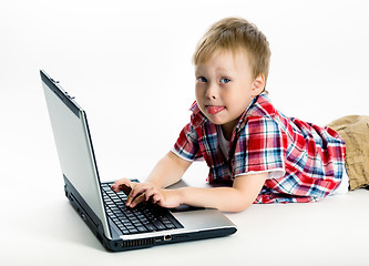 Image showing boy lying on the floor with a laptop