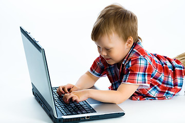 Image showing boy lying on the floor with a laptop