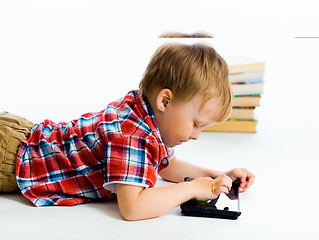 Image showing boy lying on the floor with tablet computer