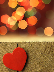 Image showing Red heart on the edge of a wooden table.