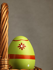 Image showing Colorful Easter egg in the company of ordinary eggs.