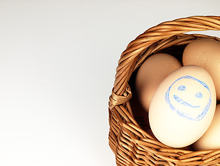 Image showing Easter egg with a happy face in the basket.