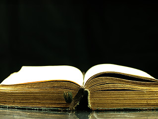 Image showing Old, open book with a damaged cover.