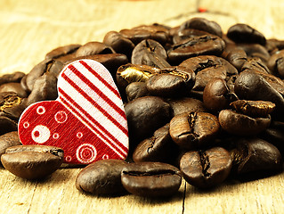 Image showing Heart and Coffee beans close-up on wooden, oak table.