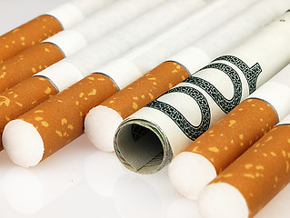 Image showing Cigarettes and money. Expensive habit.