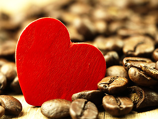 Image showing Heart and Coffee beans close-up on wooden, oak table.