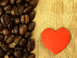 Image showing Heart and Coffee beans close-up on wooden, oak table.